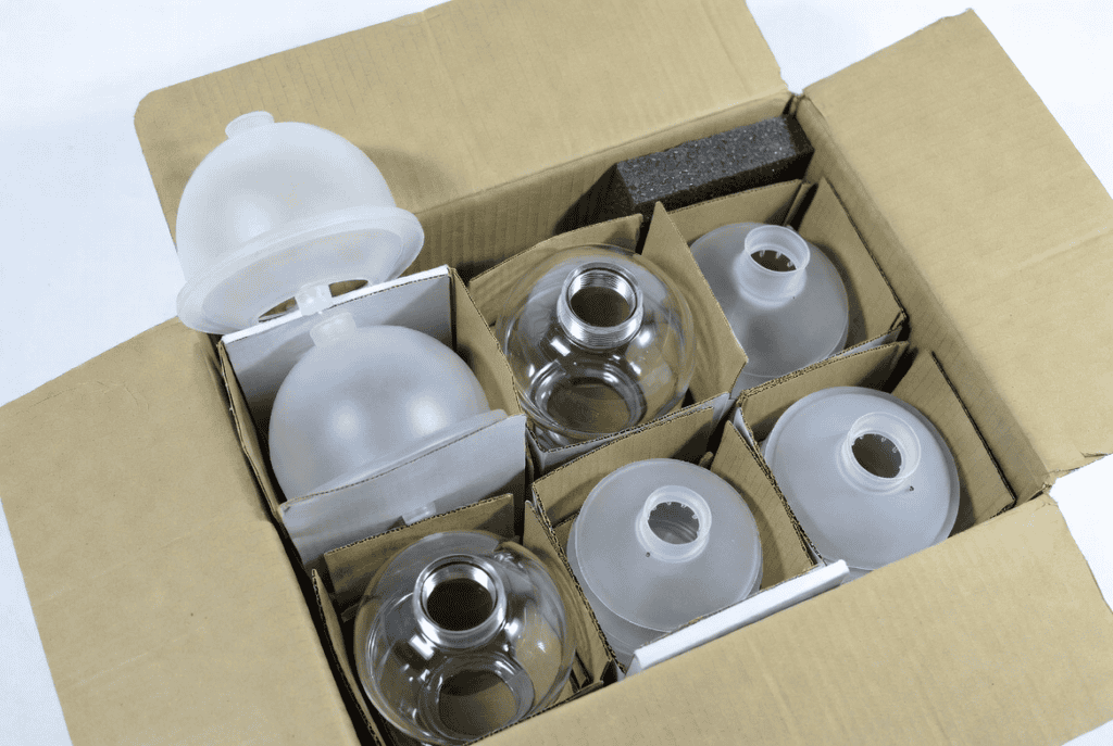 Glass lampshades in protective packaging for manufacturing and wholesale supply.