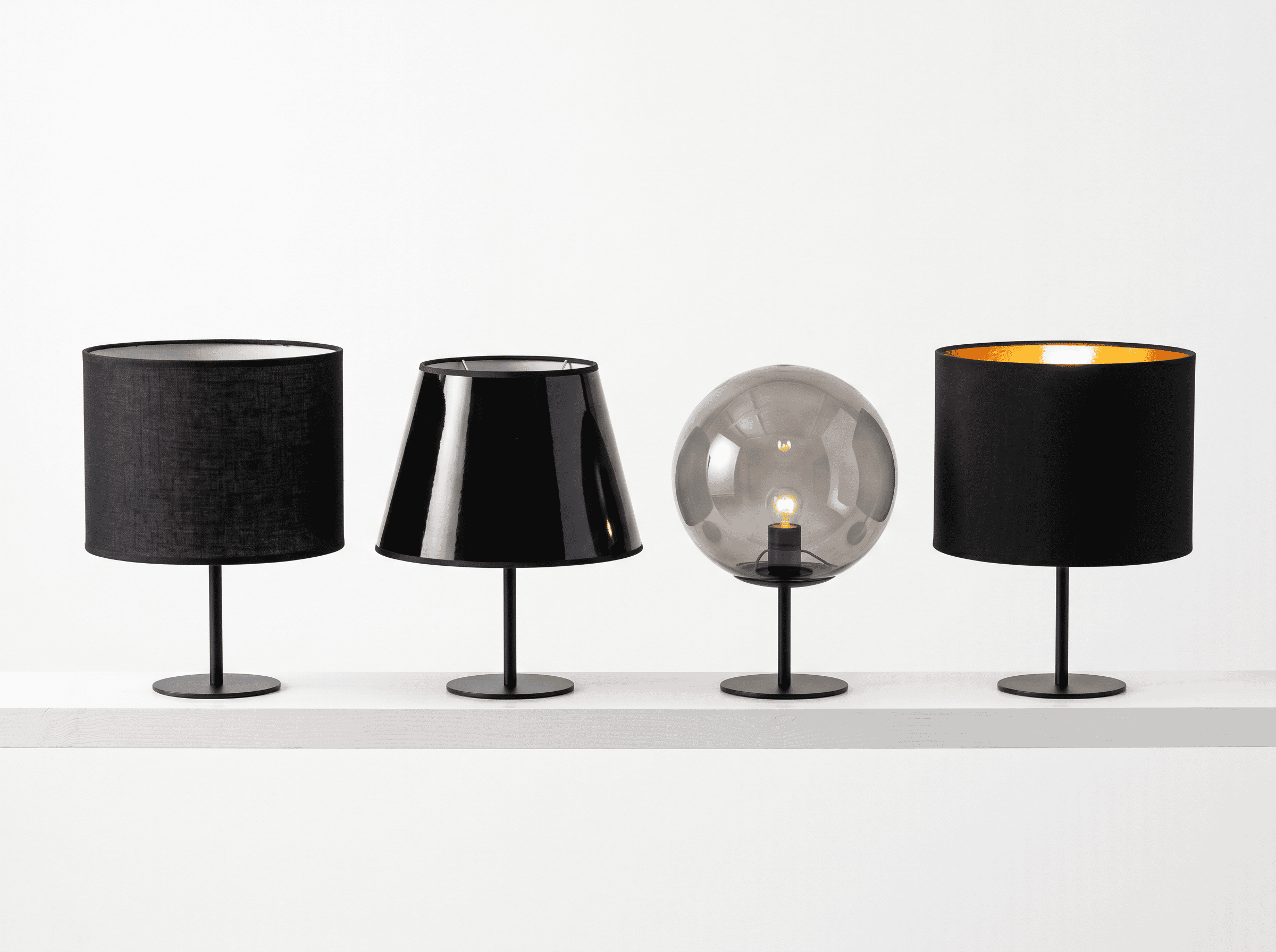 Elegant collection of glass and fabric lampshades for stylish lighting.