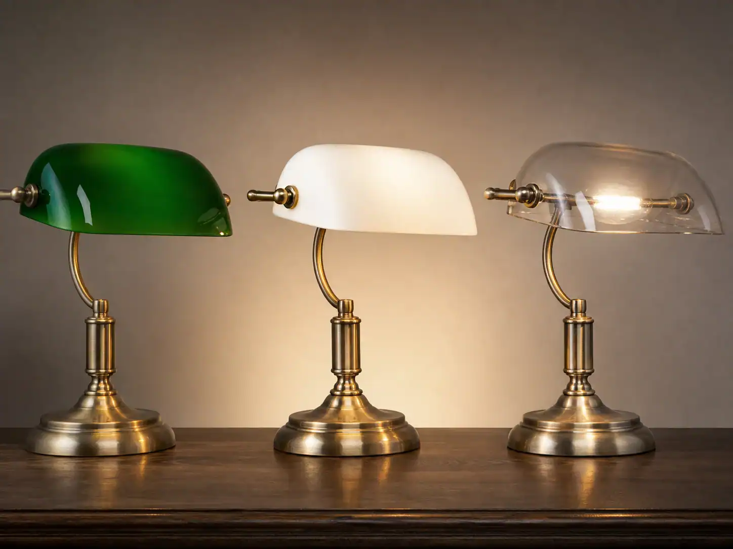 Green, opal-lined and clear banker's lamp shade samples under the same light