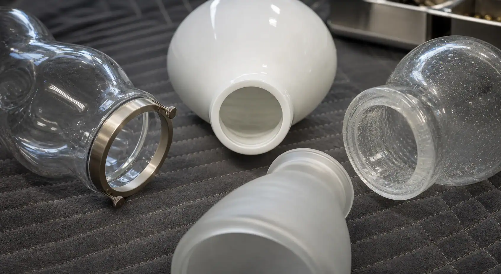 Various glass lampshades in different shapes and finishes for custom lighting solutions.