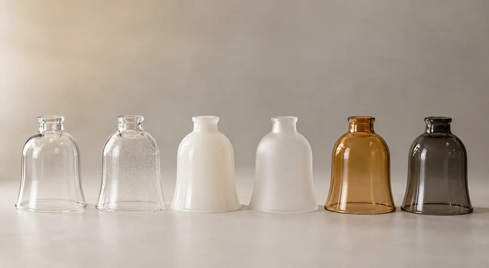 Variety of glass lampshades in clear, white, amber, and smoky colors.