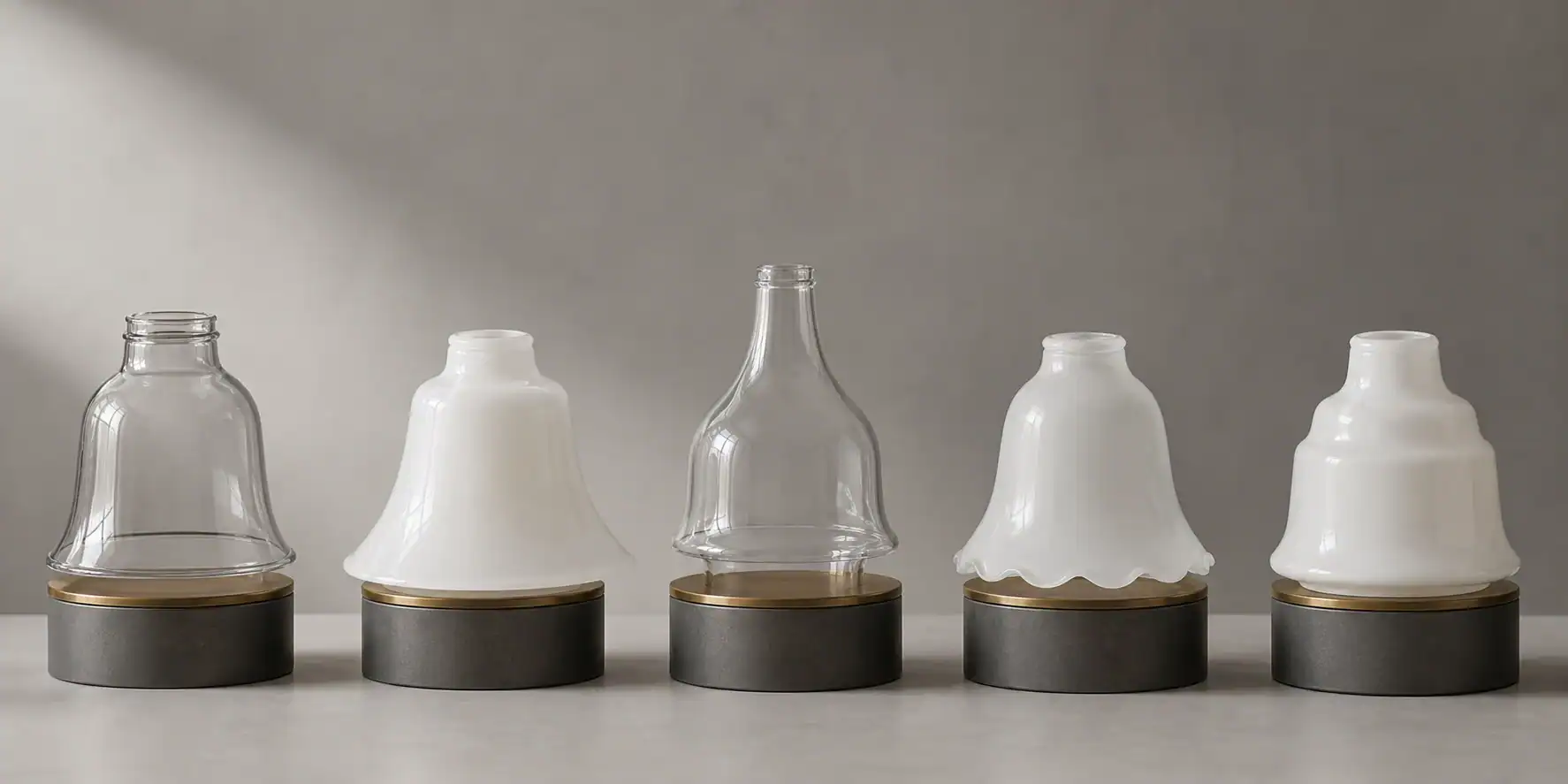 Five bell-shaped glass lamp shade profile variations in a studio lineup
