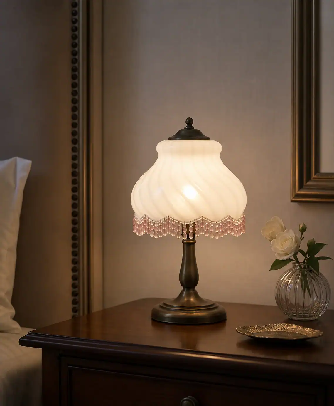 Vintage glass lampshade with intricate design on a wooden table.