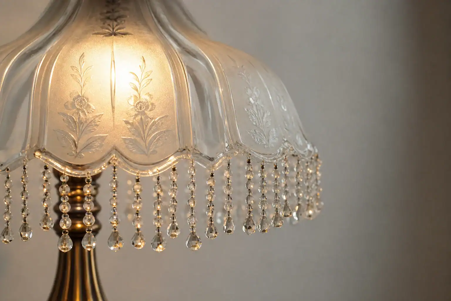 Vintage glass lampshade with intricate floral patterns and hanging crystal beads.