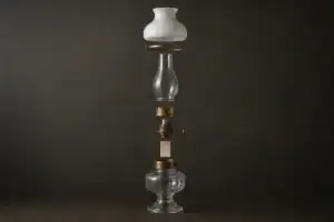 Elegant glass lampshade with vintage lamp parts on dark background.