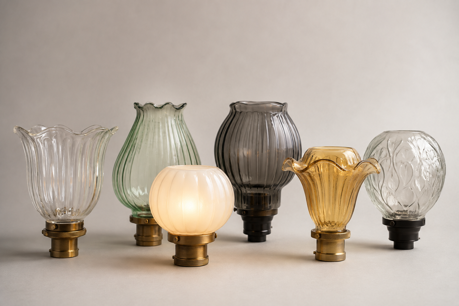 Finished family of Art Nouveau inspired glass lamp shades in coordinated profiles and finishes ready for buyer review