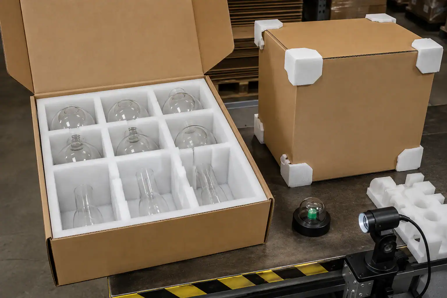 Glass lampshade packaging with protective foam and glass bulbs.