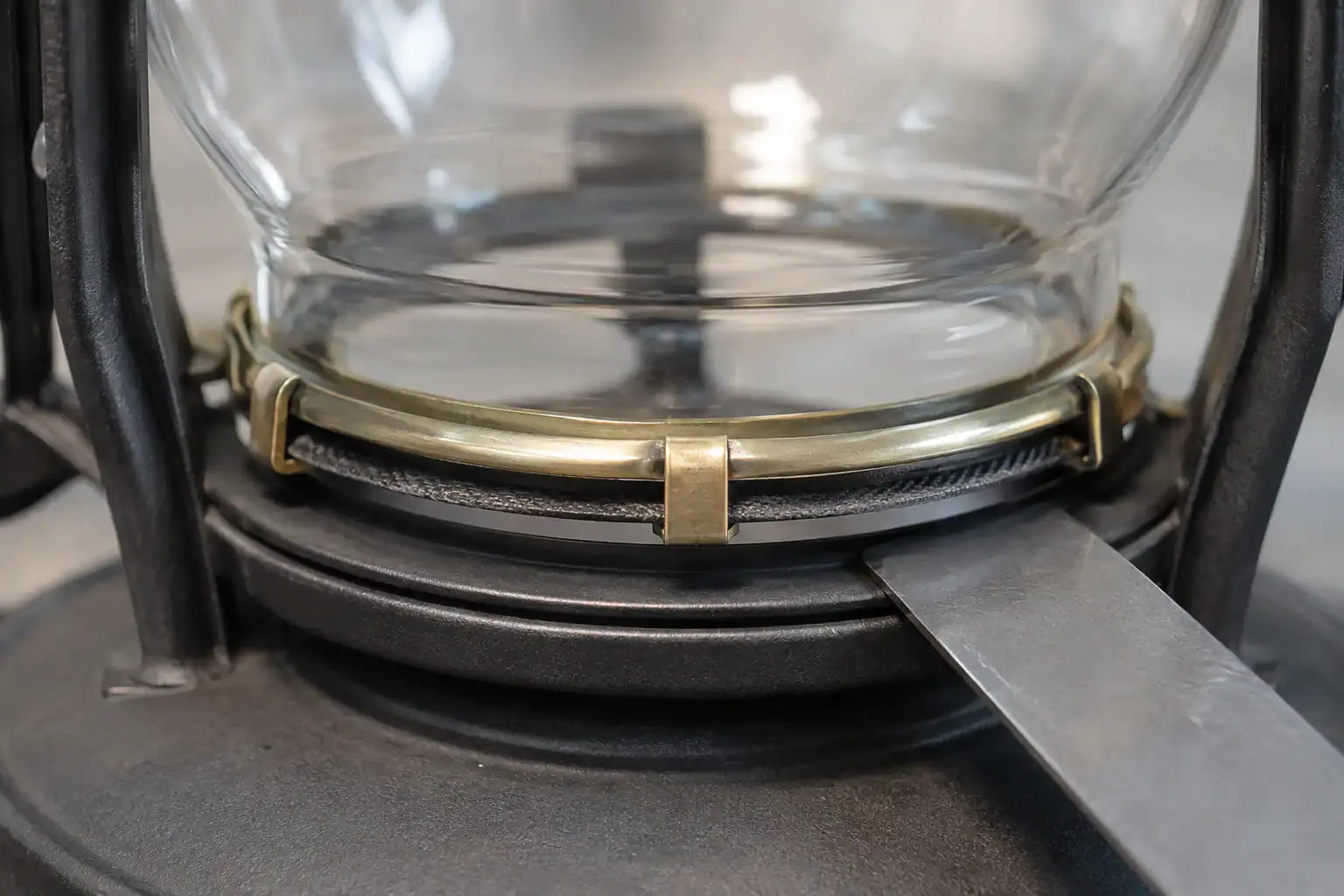 Close-up of glass lampshade being assembled in a factory.