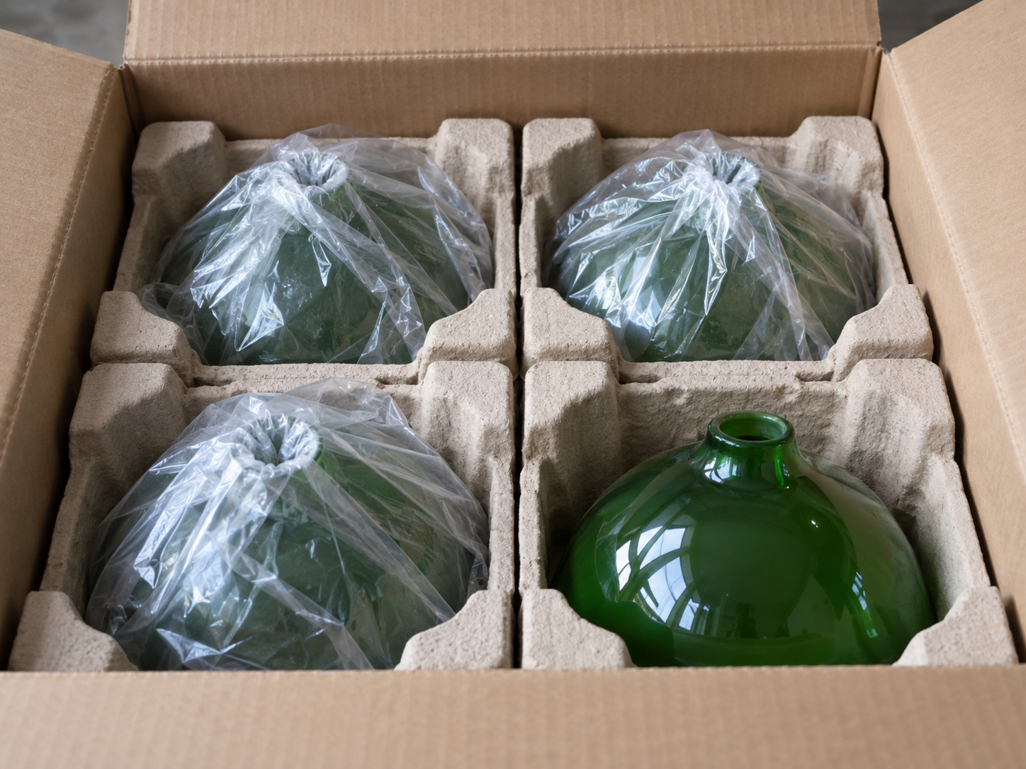 Green glass lampshades packed in foam for shipping and delivery.