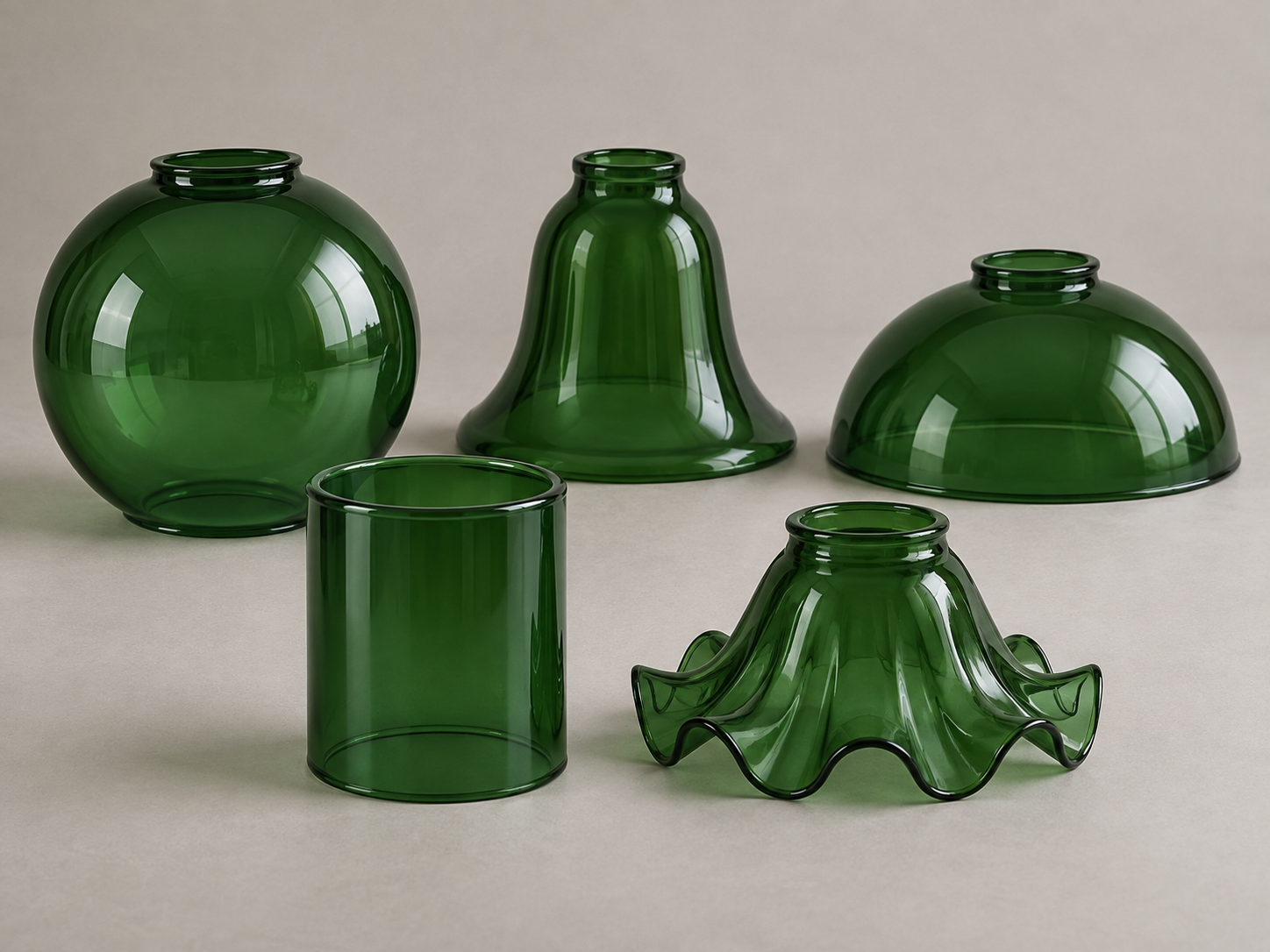 Five green glass lamp shade profiles arranged as globe bell dome cylinder and flower forms