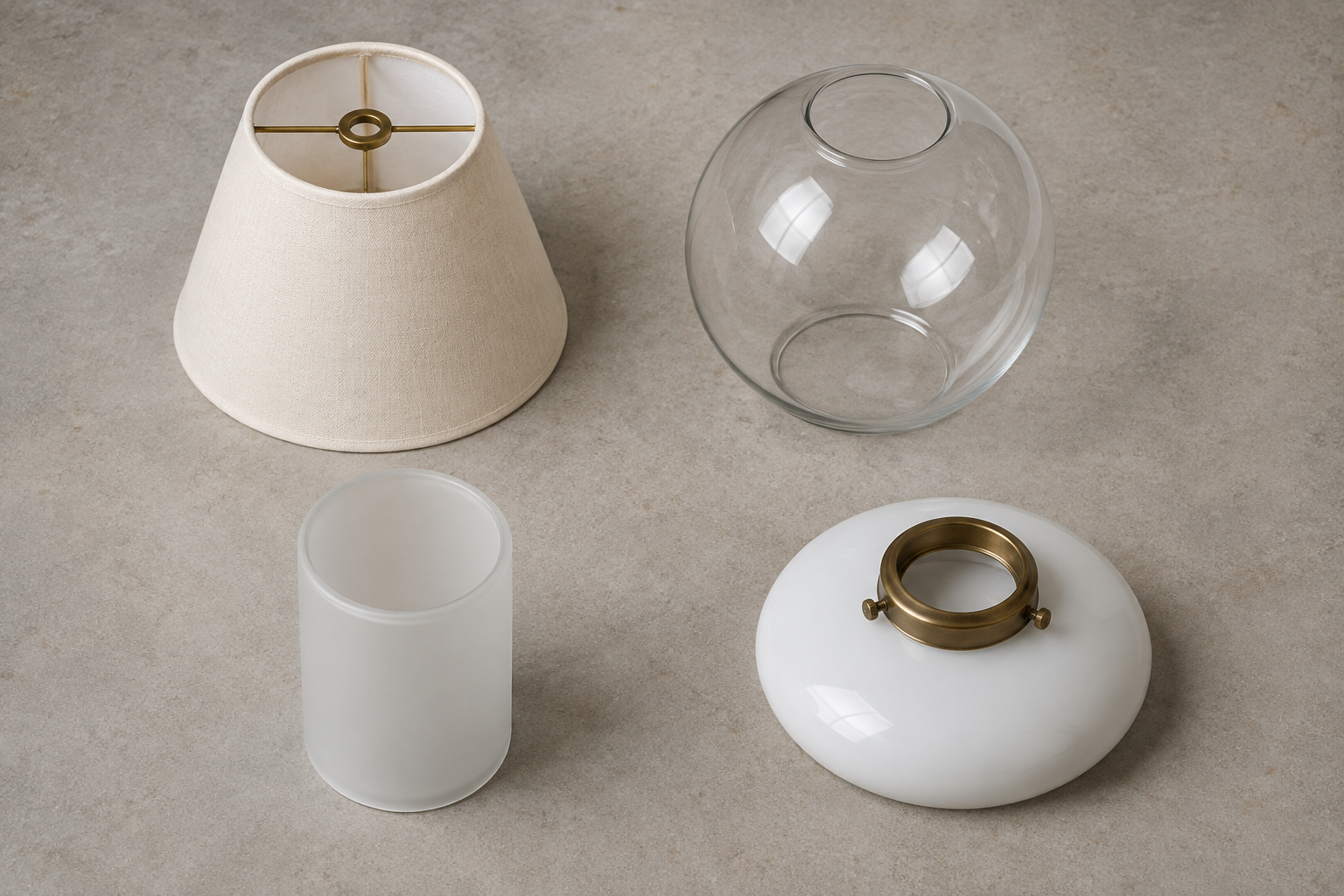 Fabric lampshade, clear glass globe, frosted cylinder shade and opal diffuser shown in a comparison arrangement