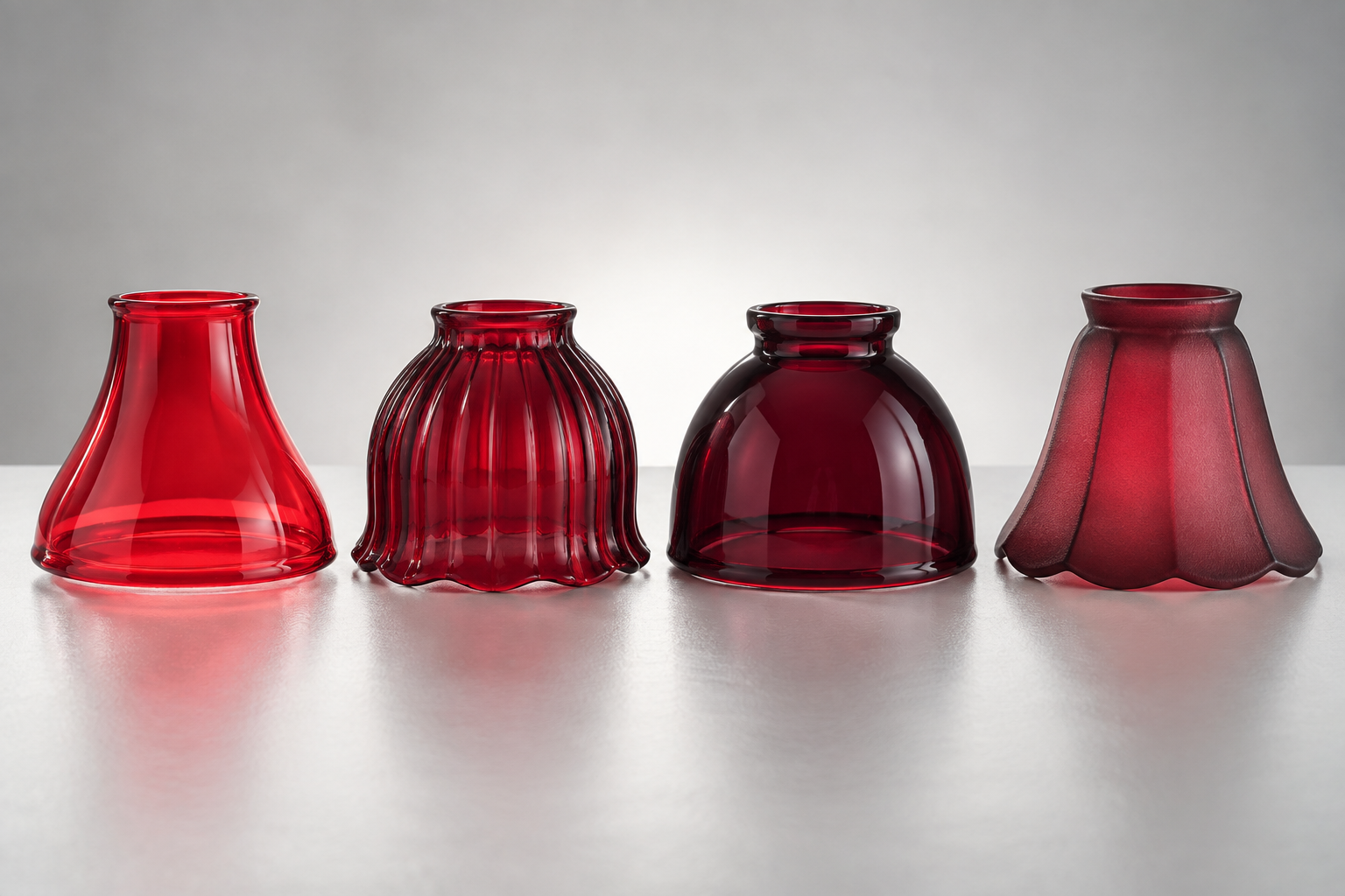 Red glass lamp shade samples ranging from transparent cherry red to deep ruby and muted cranberry