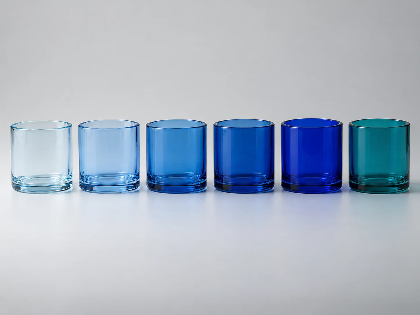 Blue glass shade samples arranged from pale ice blue through cobalt to blue green teal
