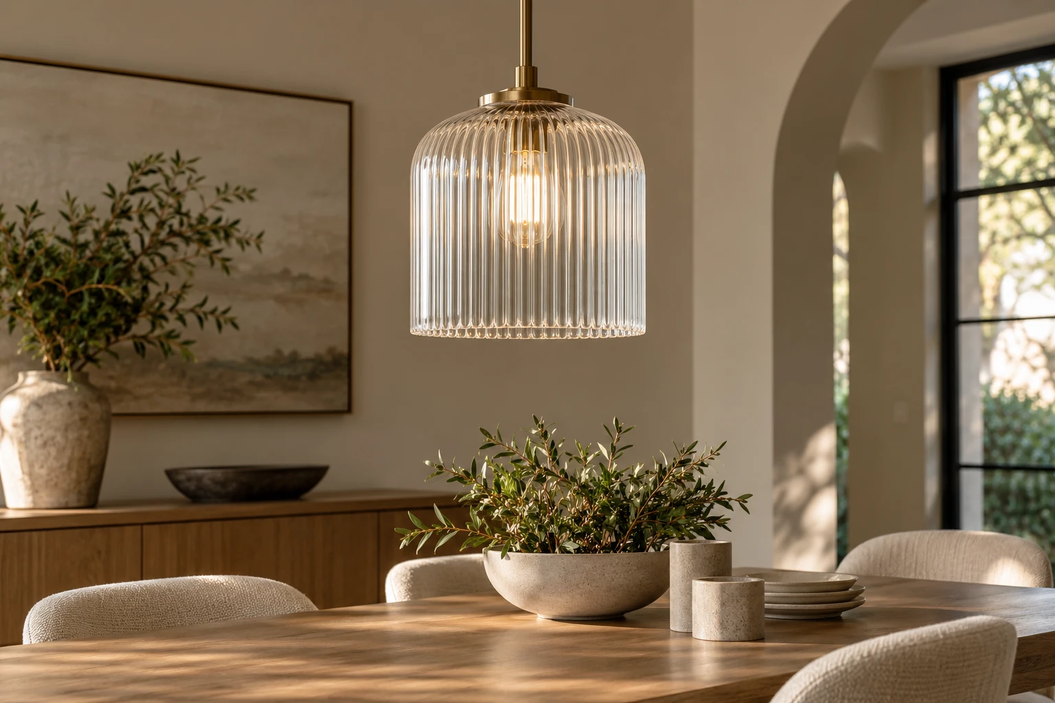 A clear fluted pendant shade concept shown over a restrained residential dining table