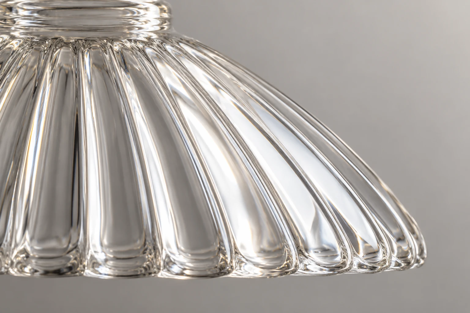 Close view of the repeated ridges and channels on a clear fluted glass shade