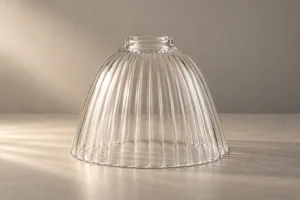 Single clear fluted glass lampshade concept shown upright on a neutral studio surface