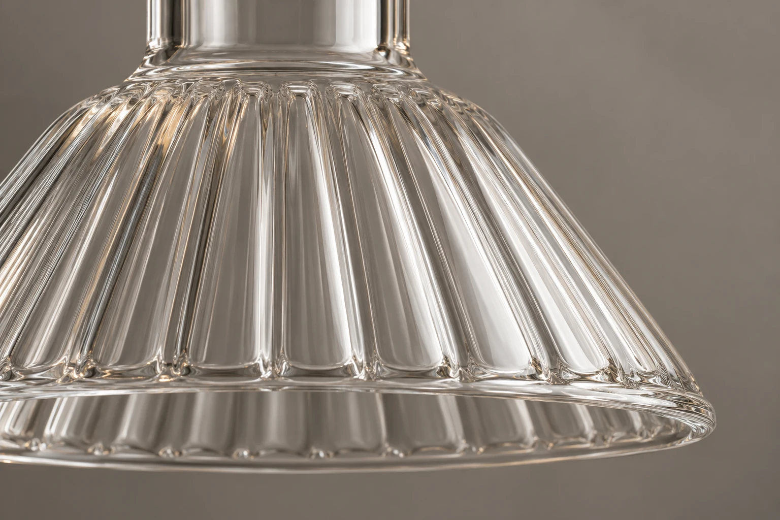 Macro view of a fluted glass shade shoulder and rim under a neutral inspection light