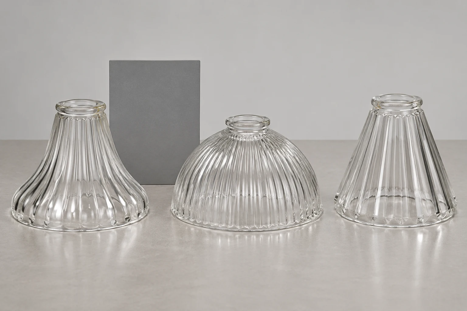 Several fluted shade concepts compared beside a plain gray reference card under consistent inspection light