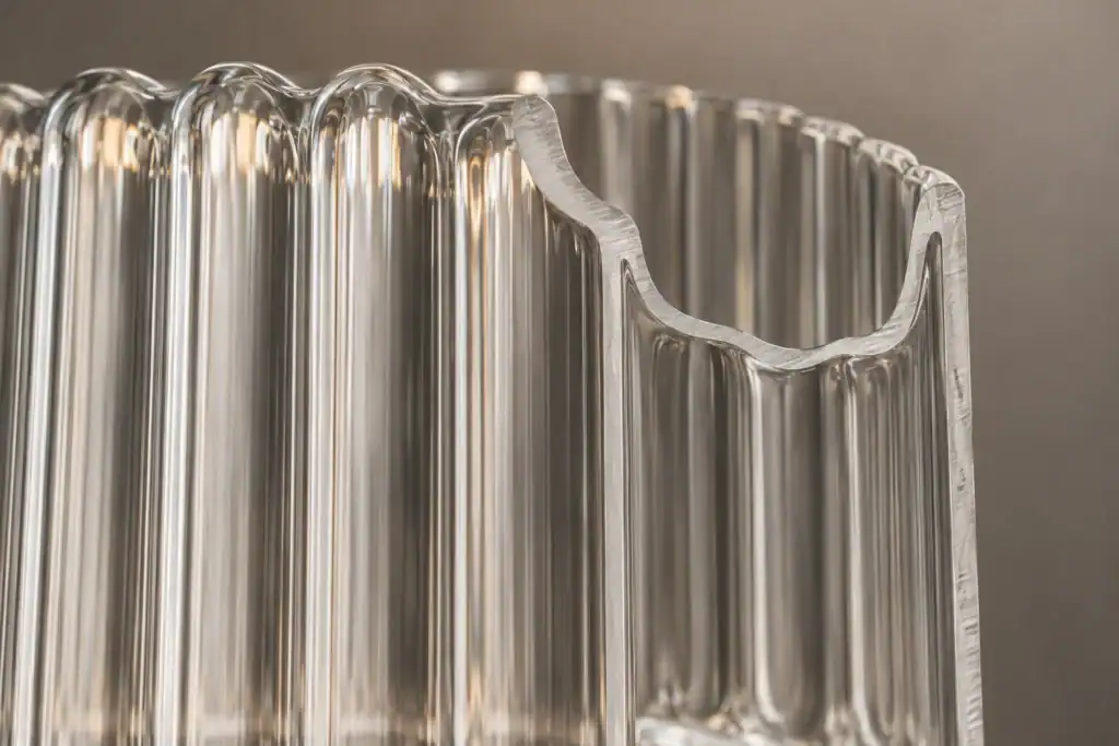 Cross-section of a ribbed pressed-glass wall showing the outer rib and inner surface